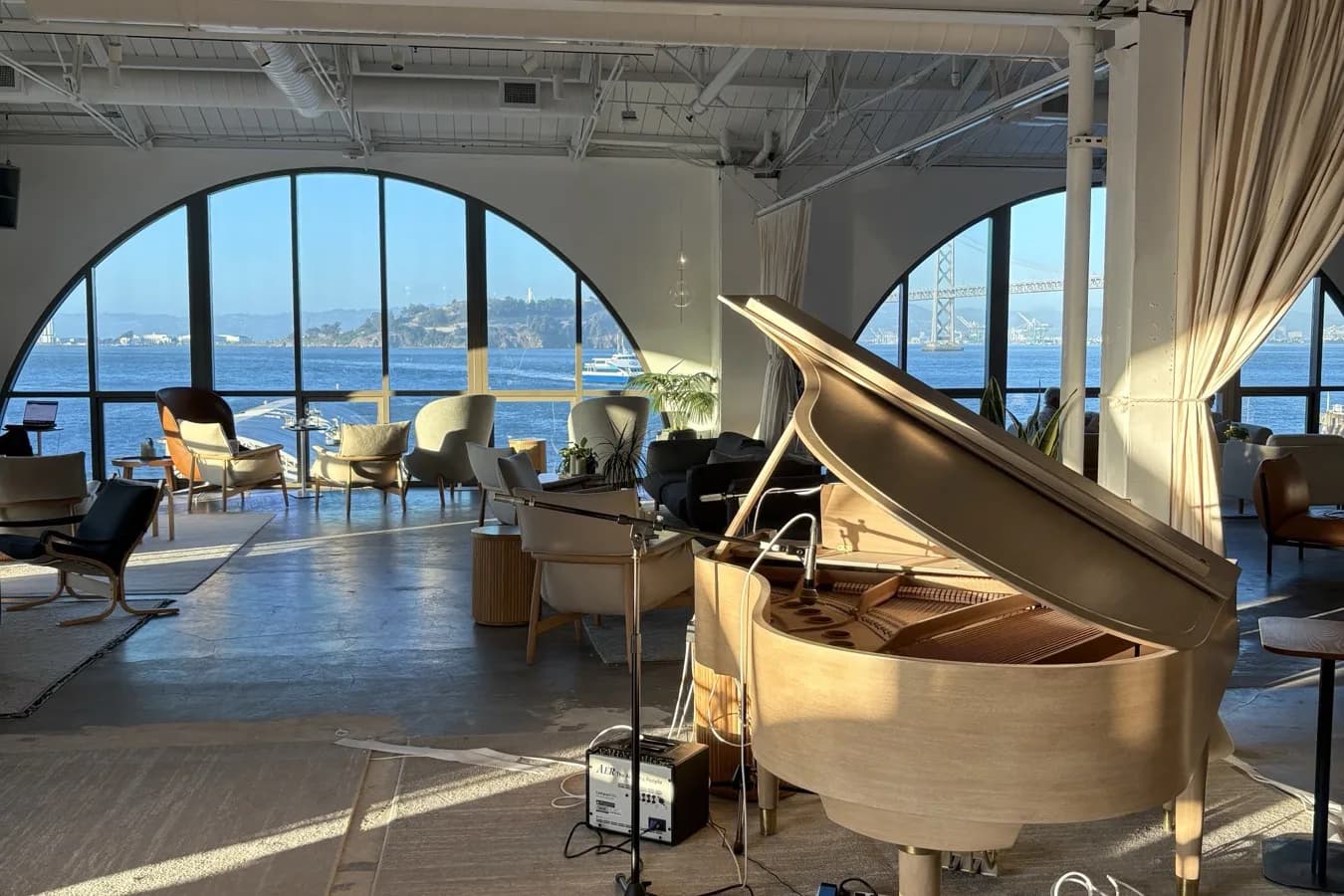 Waterfront office floor in San Francisco, the Bay Bridge visible through arched windows